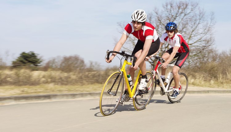 Cyclists Riding Cycles On Open Road
