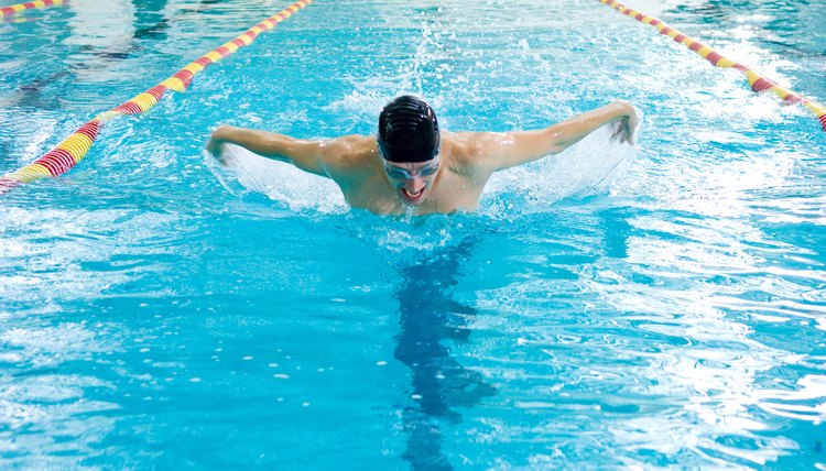 Man swimming butterfly stroke in race