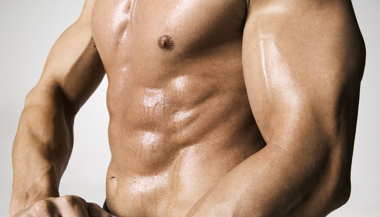 fitness portrait of a muscular male shirtless chest as he lifts weights