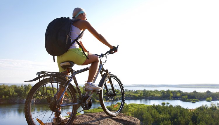 Girl with bicycle on mountain
