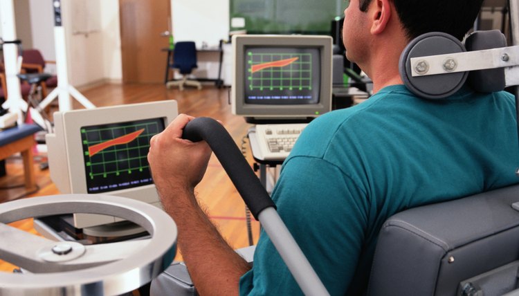 Man Watching Monitor on a Lumbar Extension Machine