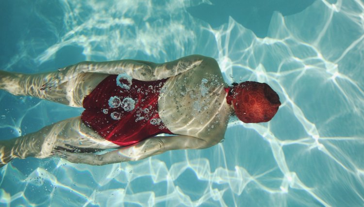 Overhead view of a woman swimming underwater