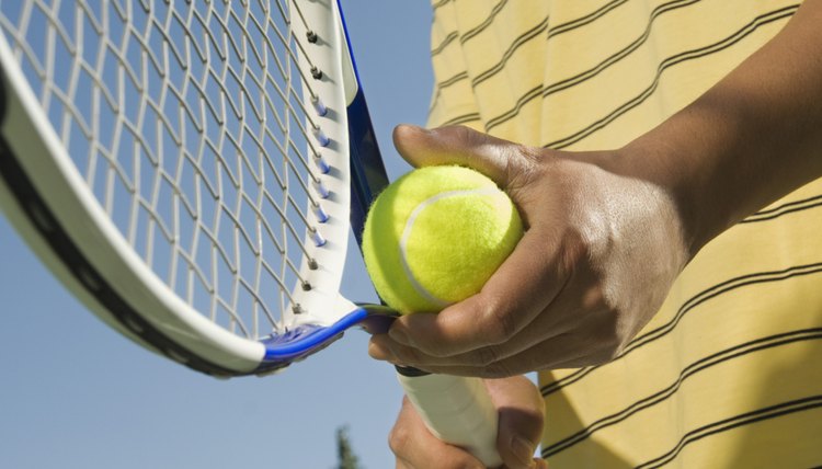 Cropped tennis player with racket and ball