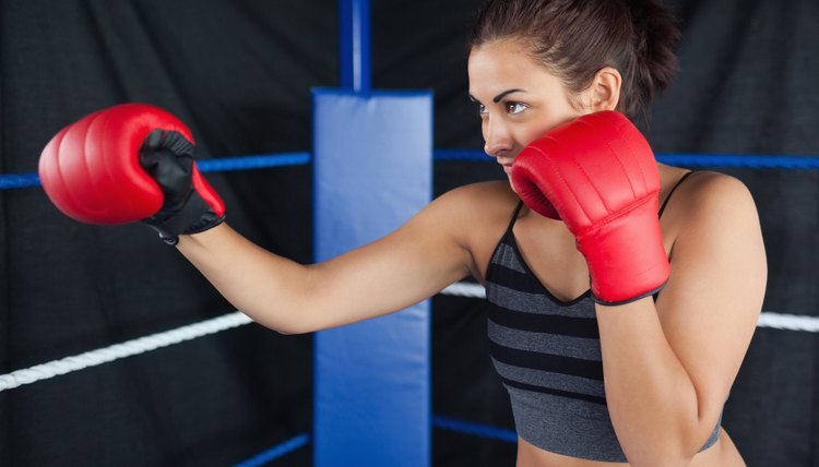 Determined female boxer practicing