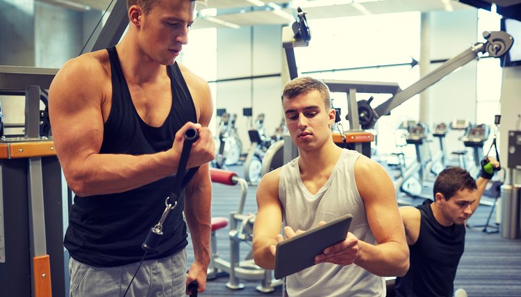 men exercising on gym machine