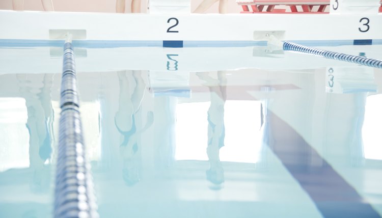 Young Women Walking Beside Indoor Swimming Pool