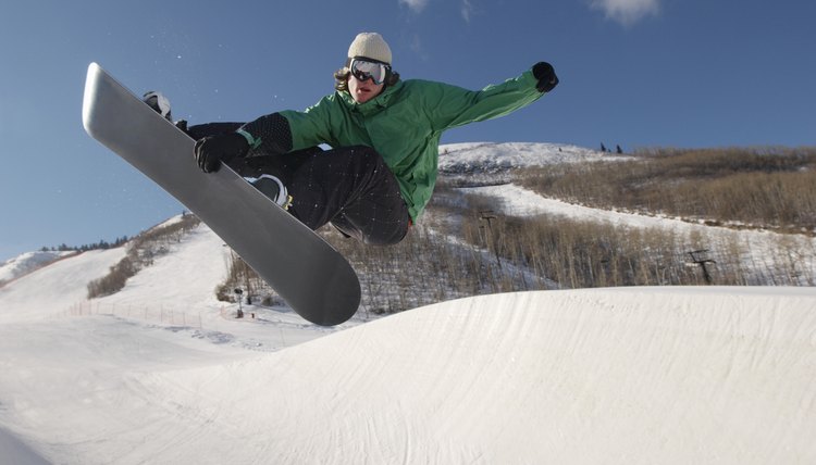 Teenage snowboarder jumping