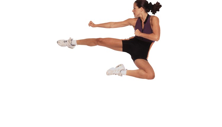 Woman jumping and kicking