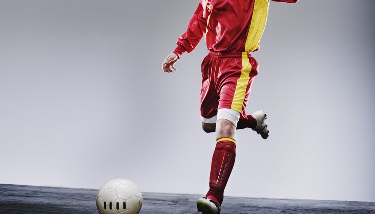 Soccer player kicking soccer ball