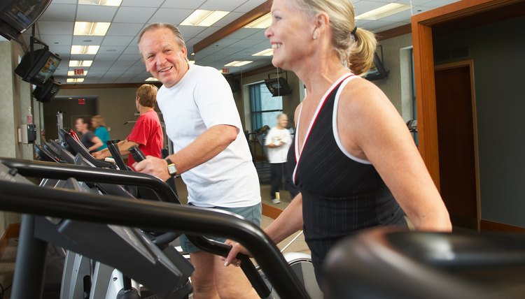 Couple exercising on gym equipment