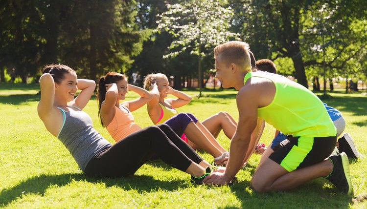 group of friends or sportsmen exercising outdoors