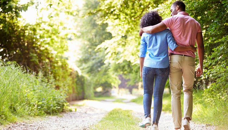 Young African American Couple Walking In Countryside
