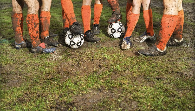 Muddy legs of soccer players