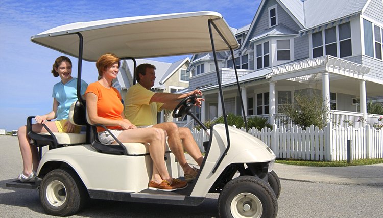 Family driving in golf cart