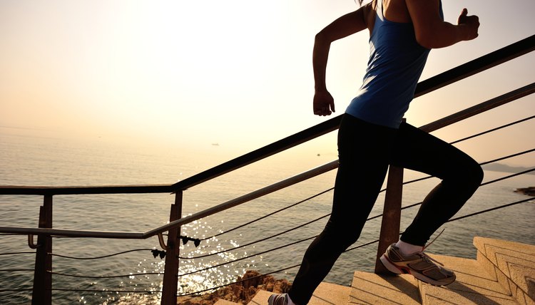 healthy lifestyle sports woman running up on stone stairs