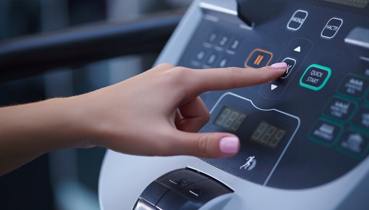 girl on a treadmill presses the button