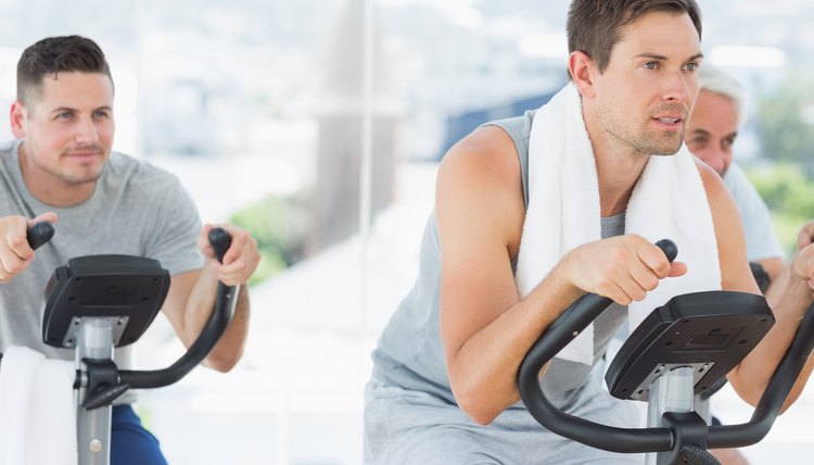Men using exercise bikes
