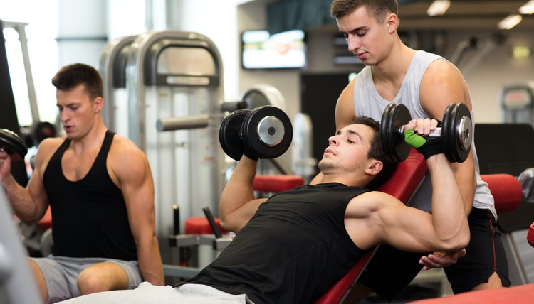group of men with dumbbells in gym