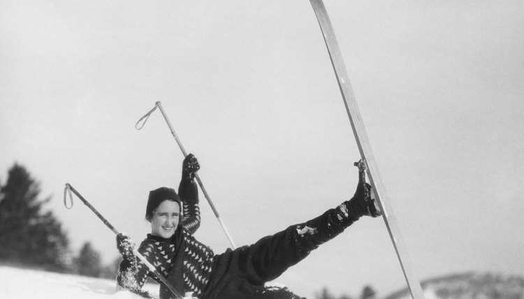 Young woman skier fallen in snow, (B&W)
