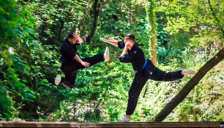 Two boys practicing martial arts. Kick and punch fighting