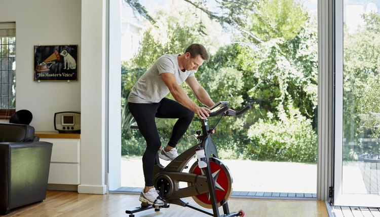 Man working out on exercise bike at home