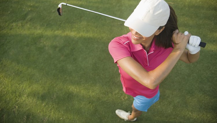 Woman Golfer Swinging Golf Club