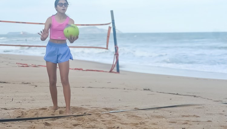 Playing beach volleyball